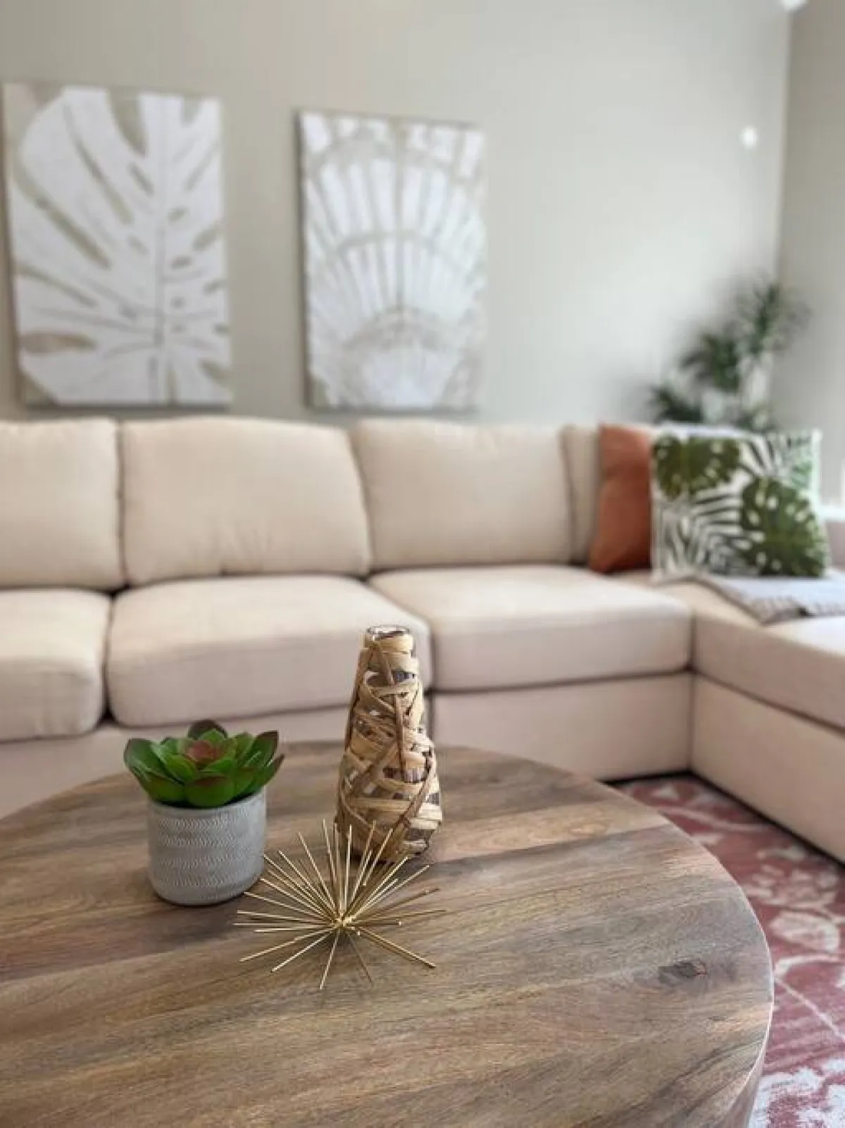 A cozy living area featuring a comfortable couch, coffee table, and decorative items, with wall art adding to the welcoming atmosphere. The arrangement encourages group gatherings, conversations, and relaxation, making it an ideal hub for social activities.